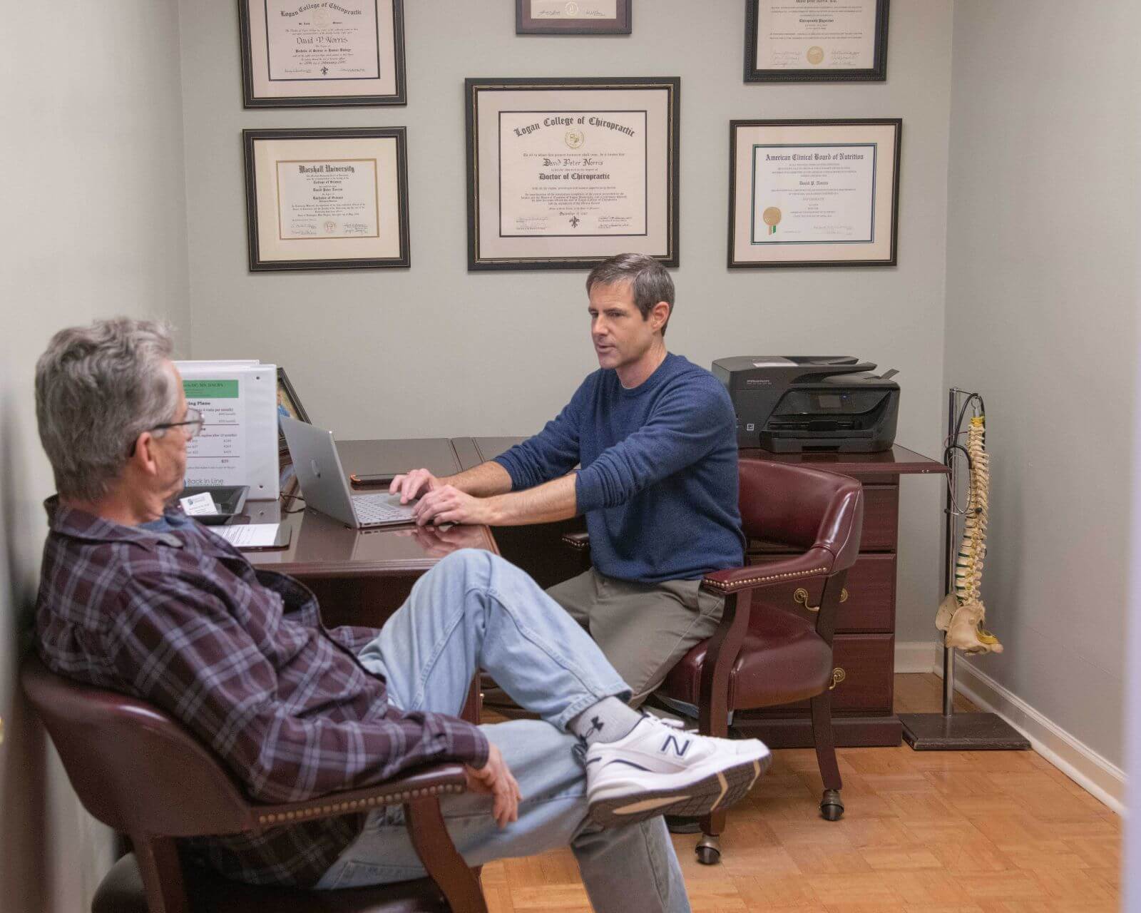 Dr. David Norris meeting with a patient during a personalized chiropractic and functional medicine consultation in Marietta Ohio